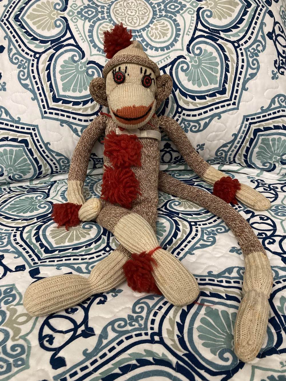 Sock Monkey on a blue and white comforter