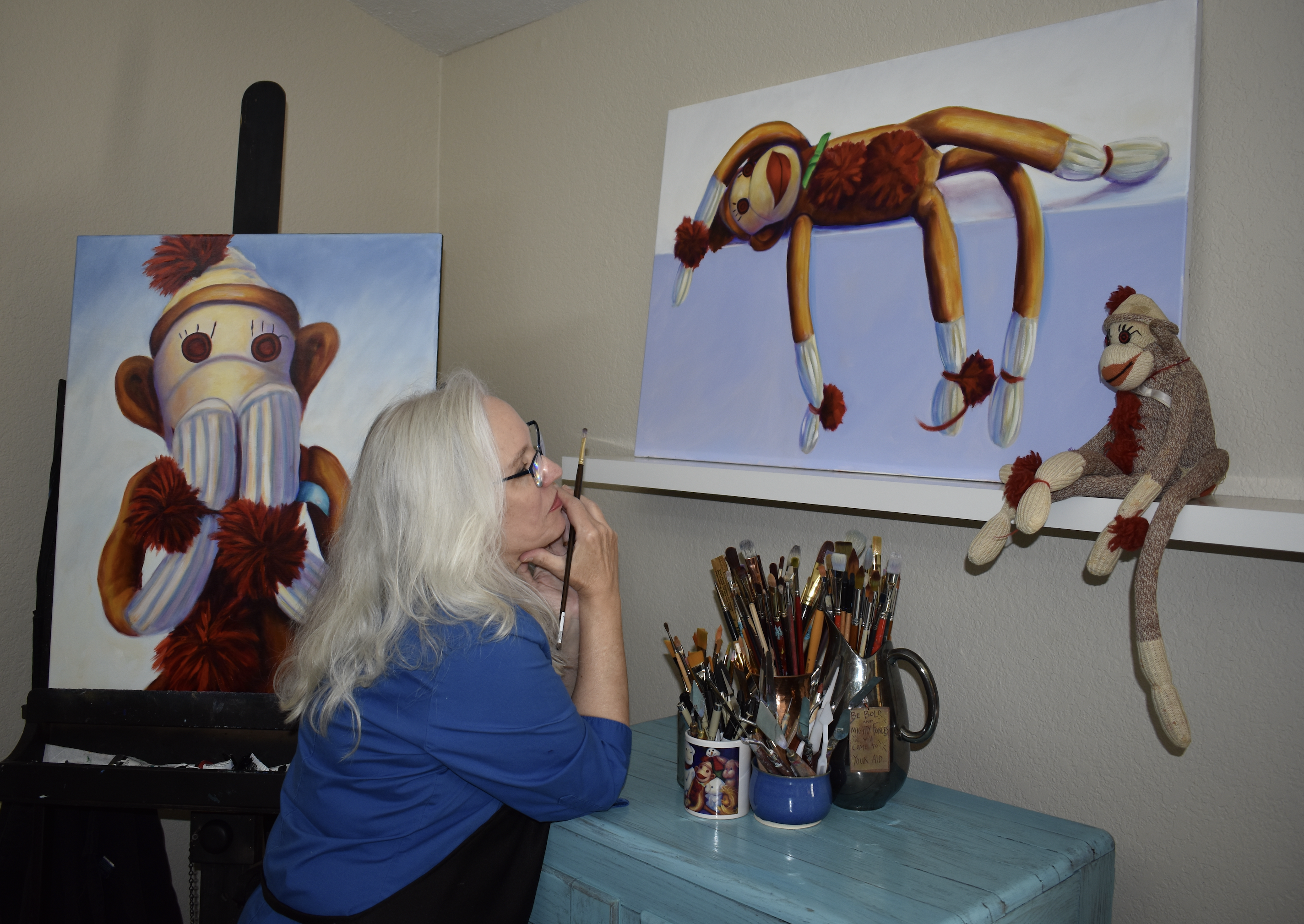Artist with Sock Monkey Paintings